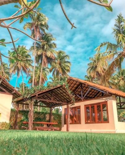a rendering of a house with palm trees at Pousada Yapara-Tyba in Japaratinga