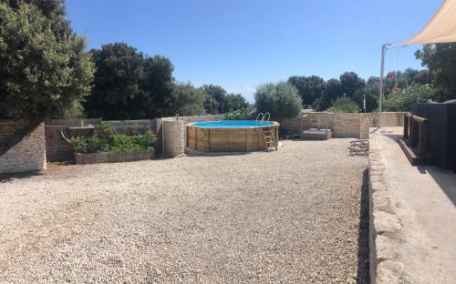 a backyard with a pool and a fence at La casa Bianca in Bonifacio