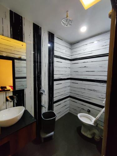 a bathroom with a sink and a toilet at Hotel Jai Surya in Patiāla