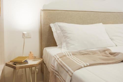 a bedroom with a bed and a side table with a book at Maison del Bassotto in Numana
