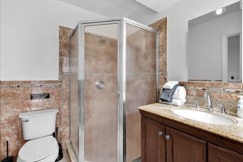 a bathroom with a shower and a toilet and a sink at Spacious 4BRS Home, Relax Backyard close to Casino in Hollywood