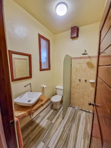 a bathroom with a sink and a toilet at Villa La Plantacion in Las Galeras
