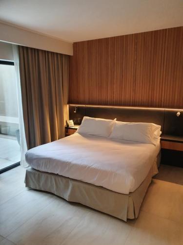 a bedroom with a large bed in a hotel room at Lastarria Hotel in Santiago