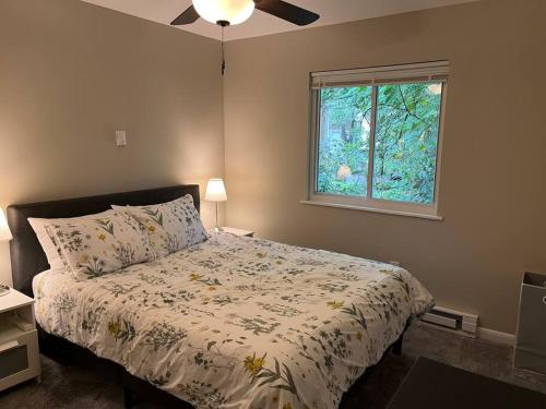 a bedroom with a bed with a comforter and a window at Carter #1 Two bedroom unit near Xavier Downtown in Cincinnati