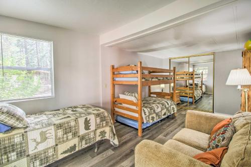 a room with two bunk beds and a couch at 2 Mi to Rainbow Lake Woodsy Retreat with Deck! in Pinetop-Lakeside