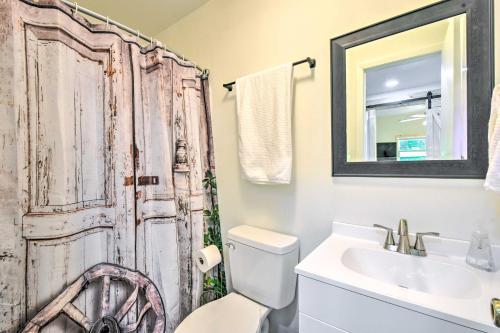 ein Bad mit einem WC, einem Waschbecken und einer Tür in der Unterkunft Grand Murphy Cabin with Fire Pit and Game Room! in Murphy