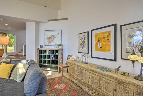 a living room with a couch and paintings on the wall at Hike, Bike and Explore Oceanfront Kingston Getaway in Kingston