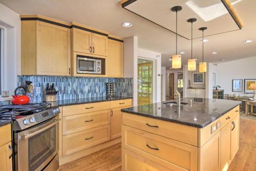 a kitchen with wooden cabinets and a stove top oven at Hike, Bike and Explore Oceanfront Kingston Getaway in Kingston