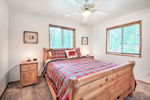 a bedroom with a wooden bed and a window at Cabin with Hot Tub, By Crater Lake Natl Park! in Klamath Falls