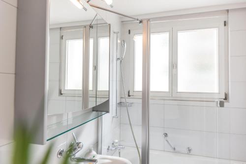 a bathroom with a shower and a sink at Joe's Apartment am Bolgen in Davos
