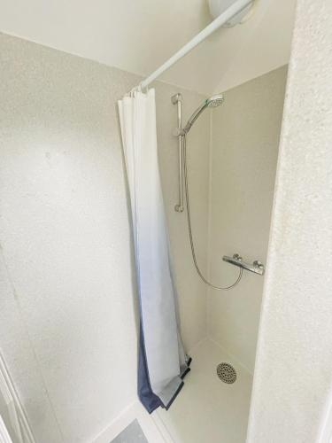 a shower with a shower curtain in a bathroom at aday - Charming loft studio in Aalborg