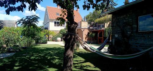 a hammock tied to a tree in a yard at T.H.NY Village Inn Cottage in Tihany