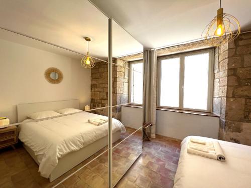 a bedroom with a bed and a glass shower at La Duchesse - Grand Appartement Au Coeur de Dijon in Dijon