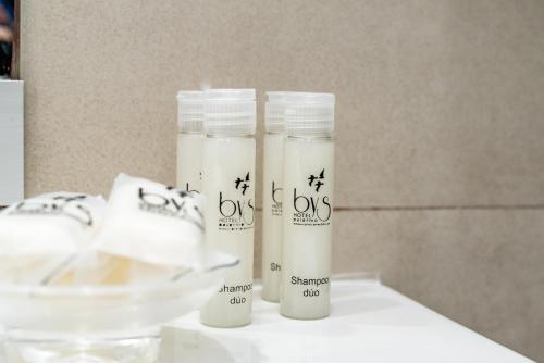 three bottles of sunscreen sitting on a table at Hotel Bys Palermo in Buenos Aires