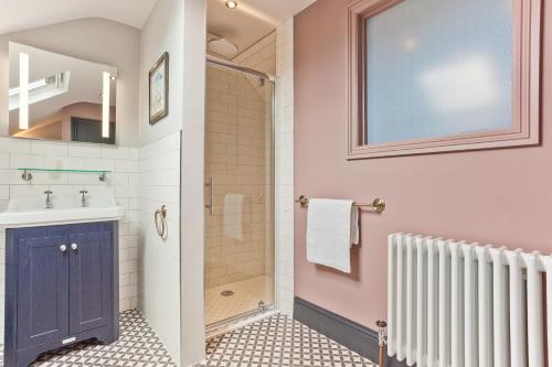 a bathroom with a shower and a sink at Bumble Choo Cottage - Windermere, Lake District in Windermere