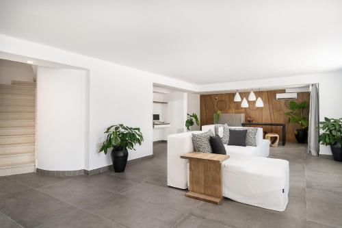 a living room with a white couch and a table at Stella Luxury Apartments in Agia Galini