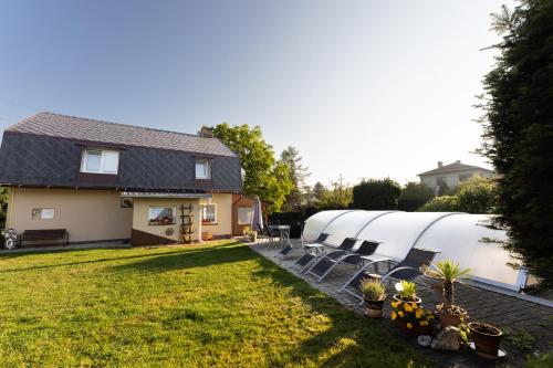 a row of domes in a yard next to a house at Penzion Mona in Jeseník