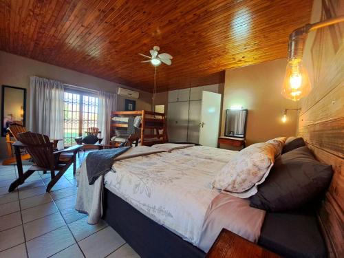 a bedroom with a large bed with a wooden ceiling at Fish eagle Guest Farm in Phalaborwa