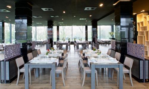 a dining room with long tables and chairs at Herbarium Hotel & Spa in Gąsawa