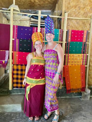 two girls in colorful dresses posing for a picture at Rinjani Houseboon in Senaru