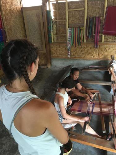 a group of people working on a table at Rinjani Houseboon in Senaru