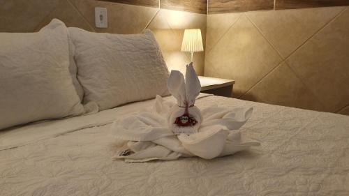 Una cama o camas en una habitación de Pousada Itapuã RS