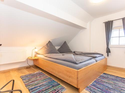 a bedroom with a wooden bed in a room at Gästehaus Schlossblick in Bad Reichenhall