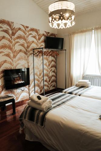 a bedroom with a large bed and a chandelier at Casa Real 110+2 in Matamorosa
