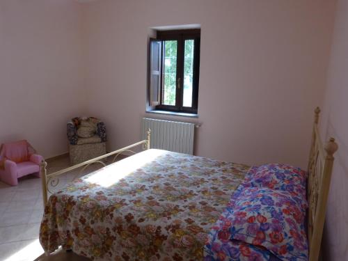 a bedroom with a bed with a quilt on it at IL Casale del Galantuomo in Castelsaraceno