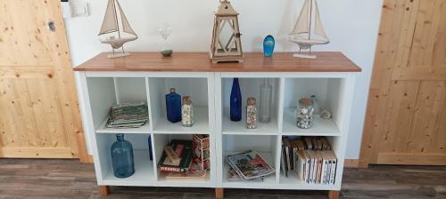 a white shelf with blue vases on it at LACADUCEE 