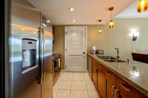 a kitchen with a stainless steel refrigerator and a sink at Honua Kai - Konea 310 in Kahana