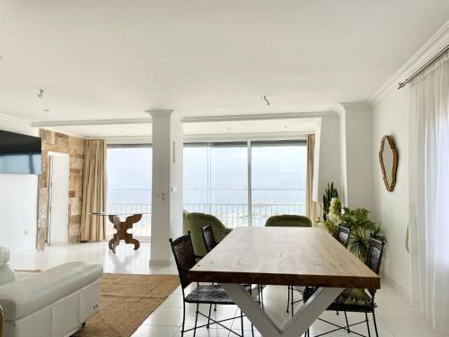 a dining room with a table and a couch at Luxury family apartment in Roses in Roses