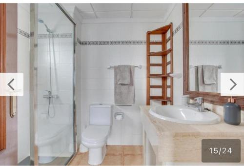 a bathroom with a toilet and a sink and a shower at Strandapartment Costa Luz-Ozean View in Tías
