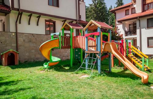a playground with a slide in the grass at "Моето Любимо Място", Смолянски езера - "My Favorite Place", Smolyan lakes in Smolyan