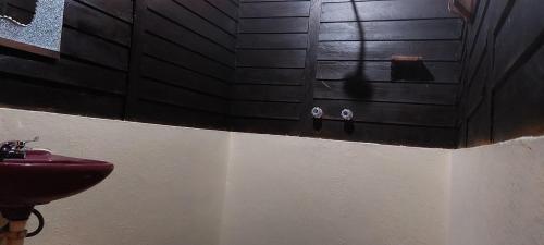 a bathroom with a red sink and a black wall at Cabañas Yax-ha in Arroyo Agua Azul