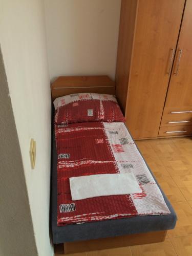 a small bed sitting in a corner of a room at Penzion Xaver in Blučina
