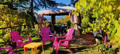 a group of chairs in a yard with a gazebo at Le rose di Mapi in Mango