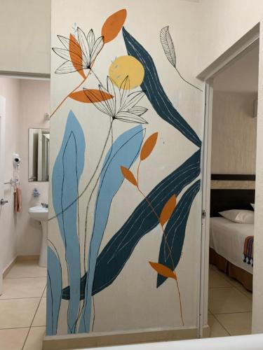 a bathroom with a mural of flowers on the wall at PlayaTurquesa Moderna Casa C/R Auto a 9 min 5ta ave in Playa del Carmen