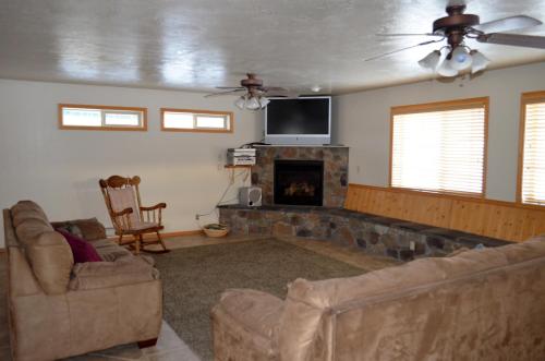 a living room with two couches and a fireplace at Sleepy J Cabins in Swan Valley