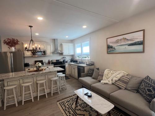 a living room with a couch and a kitchen at The Reminisce vacation home 5br/3bt,downtown BH in Bar Harbor