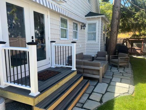 a front porch of a house with a couch and chairs at The Reminisce vacation home 5br/3bt,downtown BH in Bar Harbor