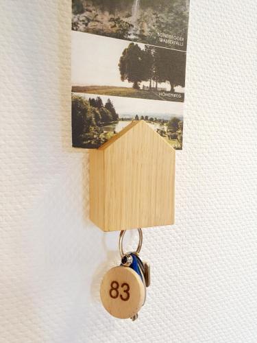 a house keychain hanging on a wall with a picture at Rosenalm Scheidegg in Scheidegg