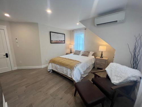 a bedroom with a bed and a chair in it at The Reminisce vacation home 5br/3bt,downtown BH in Bar Harbor