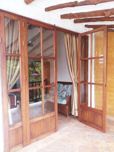a room with sliding glass doors and a couch at Casona CHARA in Barichara
