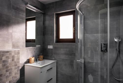 a bathroom with a sink and a shower at Vila Hradištko in Hradištko