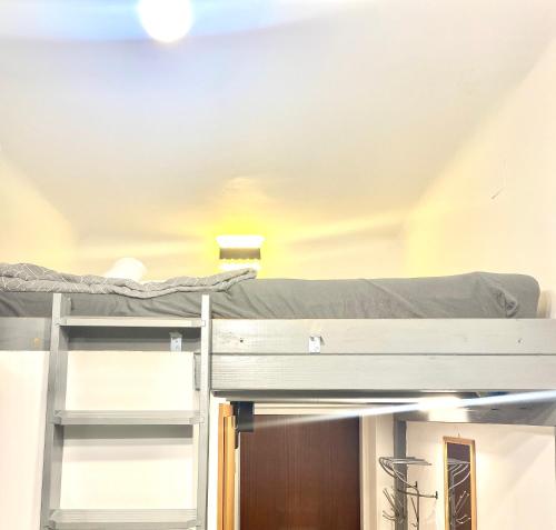 two bunk beds in a room with a ceiling at Mini Smart Studio - Self Check-in in Graz