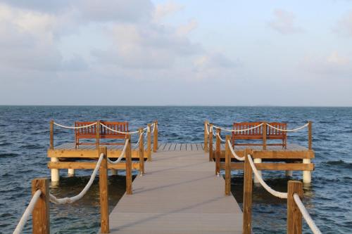two benches sitting on a pier over the water at Holiday Inn Resort Grand Cayman by IHG in George Town