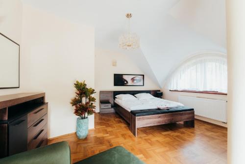 a bedroom with a bed and a table at Zarabie Residence in Myślenice