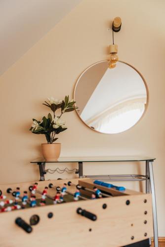 a room with a mirror and a table with some abacus at Zarabie Residence in Myślenice