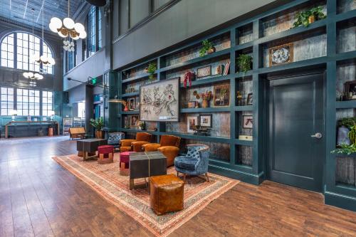 a lobby with couches and chairs in a building at Hotel Indigo Nashville - The Countrypolitan in Nashville